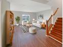 Bright living room featuring modern furniture, striped accents, hardwood floors, and ample natural light at 771 Carolina Way, Avon, IN 46123