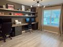 Home office featuring built-in shelves, modern desk setup, and ample natural light at 796 Booneway Ln, Bargersville, IN 46106