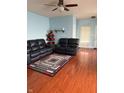 Cozy living room featuring sleek, dark sofas and a decorative rug at 8219 Lake Tree Ln, Indianapolis, IN 46217
