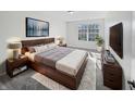 Well-lit main bedroom featuring a modern bed frame and stylish decor, creating a comfortable atmosphere at 8251 Garden Ridge Rd, Indianapolis, IN 46237