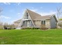 Charming A-frame home with stone accents, wraparound deck, and lush green lawn at 8394 S 600 W, Pendleton, IN 46064