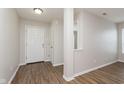 Bright entryway featuring wood-look flooring, neutral paint, and a view into adjacent rooms at 8529 Sansa St, Camby, IN 46113