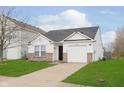Inviting single-story home with a one-car garage, complemented by a well-kept lawn and a paved driveway at 8529 Sansa St, Camby, IN 46113