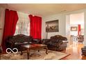 Cozy living room with hardwood floors, ornate furniture, and bright window at 10105 Yosemite Ln, Indianapolis, IN 46234