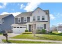 Charming two-story home with a well-manicured lawn, two-car garage and lovely landscaping at 10319 Pronghorn Ln, Indianapolis, IN 46239