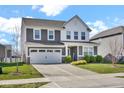 Charming two-story home with a well-manicured lawn and a long driveway at 10319 Pronghorn Ln, Indianapolis, IN 46239