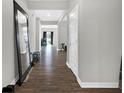 Inviting hallway with modern wood floors, leading to various rooms in the house at 10319 Pronghorn Ln, Indianapolis, IN 46239
