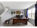 Spacious home office with a large desk, comfortable seating, and bright natural light at 10955 Balfour Dr, Noblesville, IN 46060