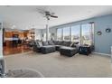 Open-concept living room connected to the kitchen and dining area, featuring large windows and a sectional sofa at 1575 Oakvista Dr, Greenwood, IN 46143