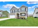 Charming home featuring a well-maintained lawn, brick accents, and a welcoming front porch at 1691 Beyers St, Fortville, IN 46040