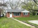 Charming brick home with green shutters, a well-manicured lawn, and a welcoming walkway at 2120 Sheffield Ave, Anderson, IN 46011
