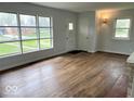 Bright and spacious living room featuring large windows and beautiful hardwood floors at 2120 Sheffield Ave, Anderson, IN 46011