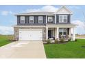 Charming two-story home with blue siding, stone accents, and a well-manicured lawn at 2538 Redding Dr, Whitestown, IN 46075