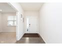 Inviting foyer features a light colored door and wood floors at 2538 Redding Dr, Whitestown, IN 46075