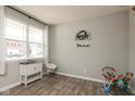 Bright and airy room with light gray walls, wood floors, and a large window with white curtains at 2960 W Patchwork Dr, Monrovia, IN 46157