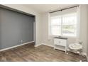Bright and airy room with light gray and blue walls, wood floors, and a large window with white curtains at 2960 W Patchwork Dr, Monrovia, IN 46157