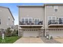 Townhome exterior showcasing a back deck and two-car garage at 3527 Brampton Ln, Westfield, IN 46074