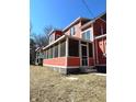 A spacious screened-in porch perfect for outdoor relaxation, attached to this charming two-story home at 359 N Jefferson St, Martinsville, IN 46151