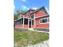Charming two-story home with a welcoming screened-in porch and red siding at 359 N Jefferson St, Martinsville, IN 46151