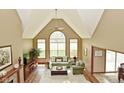Bright living room with vaulted ceiling, large windows, and comfortable seating at 4309 Summerhaven Dr, New Palestine, IN 46163