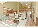 Spacious living area with an open floor plan, fireplace, and staircase to upper level at 4309 Summerhaven Dr, New Palestine, IN 46163