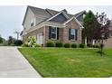 Attractive two-story home with a brick and siding exterior, well-kept lawn and a basketball hoop at 4415 Voyageur Way, Carmel, IN 46074