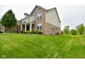 Beautiful two-story home with brick accents, siding, and a lush green lawn in a Gathering-friendly neighborhood at 4415 Voyageur Way, Carmel, IN 46074