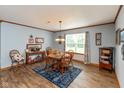 Bright dining room featuring a wooden table set and decorative accents at 464 Hummingbird Ln, Whiteland, IN 46184
