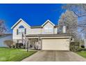 Charming two-story home featuring a well-maintained lawn and attached two-car garage at 5397 Ripplingbrook Way, Carmel, IN 46033