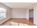 Bright and spacious living room with hardwood floors and large windows for ample light at 5397 Ripplingbrook Way, Carmel, IN 46033