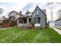 Beautiful home showcasing its unique architectural style, covered porch, and inviting curb appeal at 5654 Broadway St, Indianapolis, IN 46220