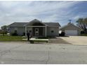 Lovely home featuring a detached garage, a welcoming porch, and a well-manicured yard at 600 Fairlane Dr, Edinburgh, IN 46124