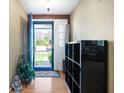Bright entryway featuring a blue front door, laminate flooring, and neutral wall colors at 617 Kokomo Ln, Indianapolis, IN 46241