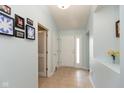 Bright foyer featuring neutral tile floors, sky blue walls, decor, and a white front door with sidelight at 6174 Bristlecone Dr, Fishers, IN 46038