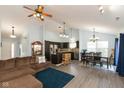 Open floor plan showcasing the kitchen, dining, and living areas with hardwood floors and bright, sky blue walls at 6174 Bristlecone Dr, Fishers, IN 46038