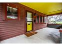 Welcoming front porch with a bright yellow door, and classic architectural detailing at 622 E 37Th St, Indianapolis, IN 46205
