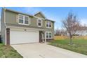 Lovely two-story home with a two-car garage and long drive on a sprawling lawn at 6316 Avacado Dr, Indianapolis, IN 46217