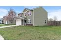 A charming two-story home with lush lawn and attached two-car garage on a sunny day at 6316 Avacado Dr, Indianapolis, IN 46217