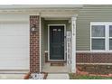 Close-up of the front door with brickwork, sidelight, and a welcoming entrance at 6316 Avacado Dr, Indianapolis, IN 46217