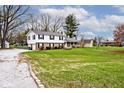 Expansive front yard showcasing a two-story home with attached two car garage and mature trees at 6436 Lakeland Blvd, Indianapolis, IN 46234