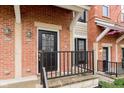 Close-up of brick townhouse entrance with black door and railings at 6585 Reserve Dr, Indianapolis, IN 46220