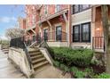 Brick townhomes with front patios, black railings and mature landscaping at 6585 Reserve Dr, Indianapolis, IN 46220