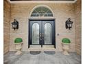 Elegant double front doors with decorative glass and sconces, enhancing curb appeal at 6802 Carters Grove Dr, Noblesville, IN 46062