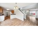 Open floor plan with hardwood floors connecting the kitchen, dining, and living areas at 693 Cembra Dr, Greenwood, IN 46143