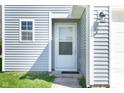 Up close view of the front entrance including storm door and sidelight at 7010 Beargrass Ct, Indianapolis, IN 46241