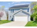 Charming two-story home with vinyl siding, solar panels, and a well-manicured lawn at 7010 Beargrass Ct, Indianapolis, IN 46241