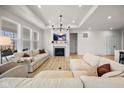 Bright living room with modern fireplace, white couches, and light hardwood flooring at 7210 Covington St, Lebanon, IN 46052