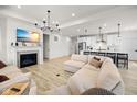 Open concept living area with fireplace, tv, and kitchen featuring pendant lighting at 7210 Covington St, Lebanon, IN 46052