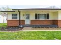 Inviting entryway with decorative door, fresh landscaping, and brick facade details at 739 Laurel Ln, Fortville, IN 46040
