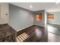 Spacious open-plan living room with hardwood floors, neutral walls, and a sliding glass door at 7606 Miracle Rd, Indianapolis, IN 46237